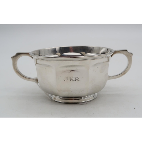 355 - A George V silver twin-handled Christening cup, by Adie Brothers ltd, of faceted form, engraved to t... 