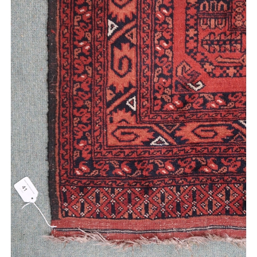 41 - A red ground Bokhara rug with six geometric lozenges and multiple borders, 155cm long x 105cm wide&n... 