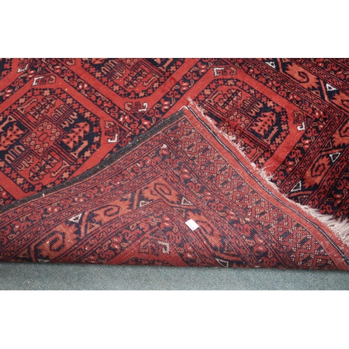 41 - A red ground Bokhara rug with six geometric lozenges and multiple borders, 155cm long x 105cm wide&n... 