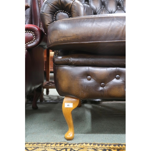 46 - A 20th century brown leather button back Chesterfield style two seater settee on cabriole supports, ... 