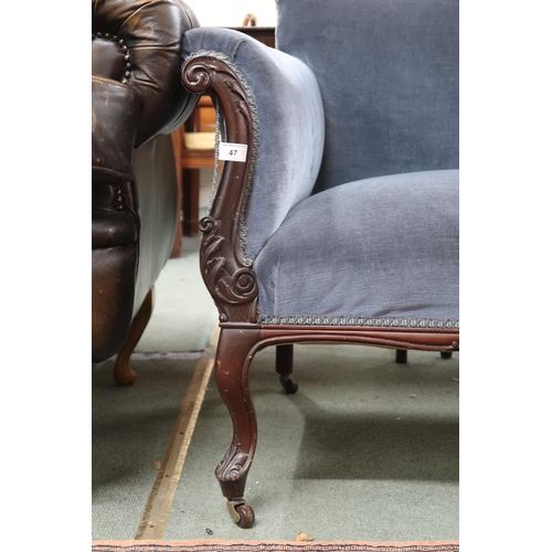 47 - A Victorian blue velour upholstered sofa on carved cabriole supports terminating in ceramic casters,... 
