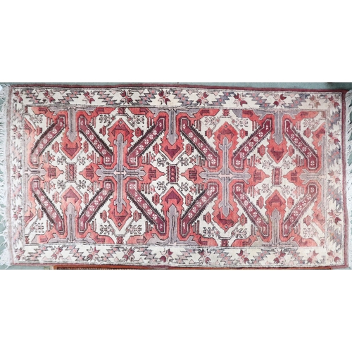 54 - A cream ground Caucasian Chelebred rug with two pink crossed medallions and geometric borders, 186cm... 