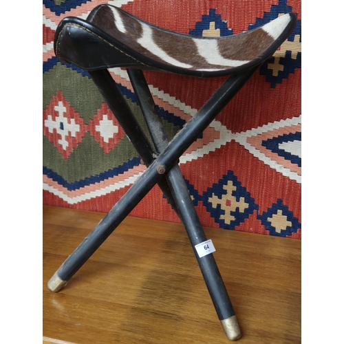 64 - A mid 20th century safari style three legged folding stool with leather and faux zebra patterned sea... 