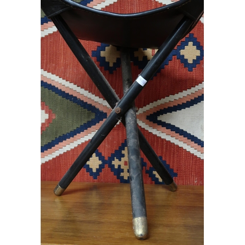 64 - A mid 20th century safari style three legged folding stool with leather and faux zebra patterned sea... 