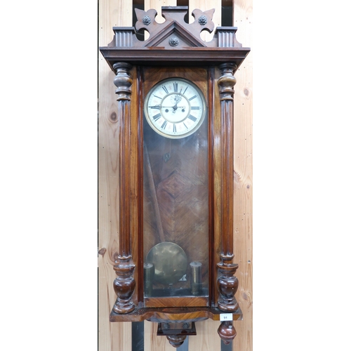 91 - A 20th century walnut cased Austrian style wall clock with white dial bearing Roman numerals and sub... 