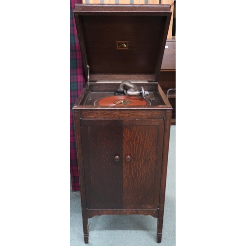 97 - An early 20th century oak cased His Masters Voice hand cranked gramophone, 92cm high x 46cm wide x 5... 