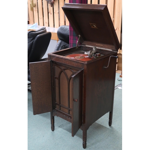 97 - An early 20th century oak cased His Masters Voice hand cranked gramophone, 92cm high x 46cm wide x 5... 