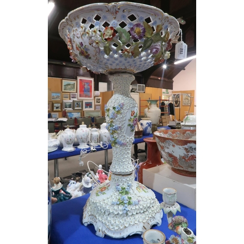 253 - A large continental flower encrusted centrepiece with reticulated bowl top, together with a pair of ... 