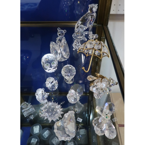 258 - A small collection of Swarovski crystal including a seated Cheetah, assorted other animals and birds