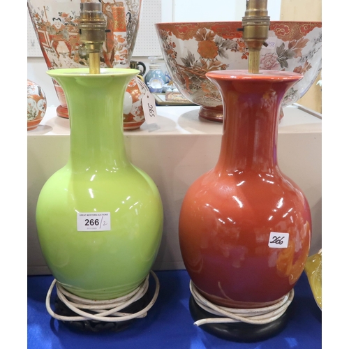 266 - Two oriental style lamps on wooden bases, one in lime green glaze, the other in a russet glaze