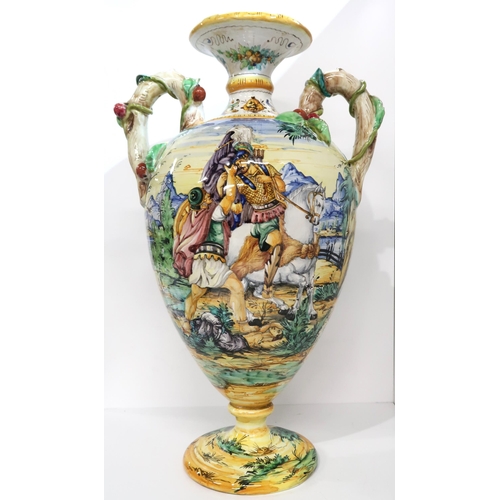 274A - An Italian faience two handled urn painted with figures in a landscape