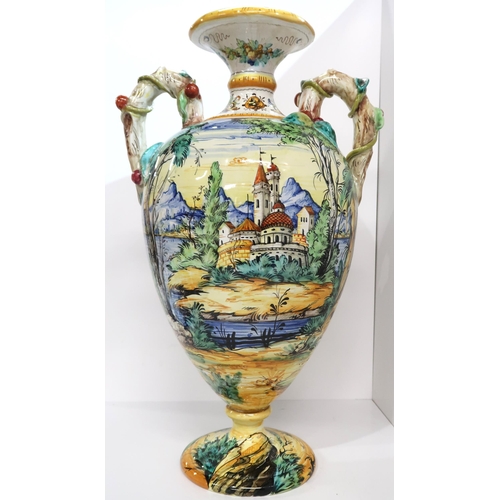 274A - An Italian faience two handled urn painted with figures in a landscape