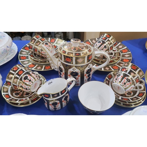 284 - A Royal Crown Derby 1128 imari teaset comprising teapot, eight cups, saucers, plates, two cake plate... 