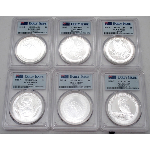 415 - Australian silver commemorative coin sets in wood display cases, each containing three silver coins.... 