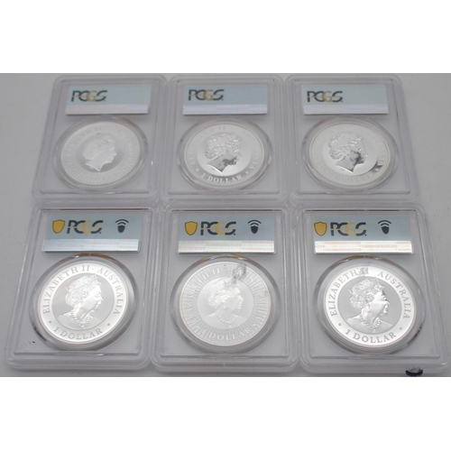 415 - Australian silver commemorative coin sets in wood display cases, each containing three silver coins.... 