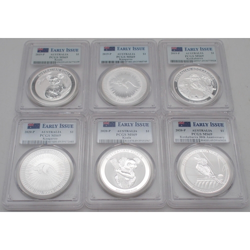 415 - Australian silver commemorative coin sets in wood display cases, each containing three silver coins.... 