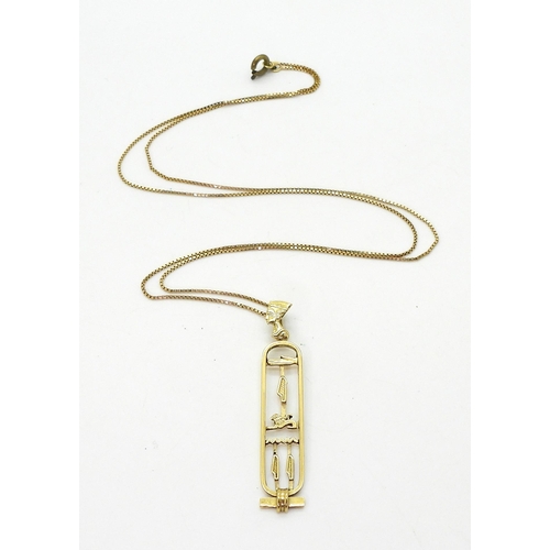 706 - An Egyptian gold hieroglyph pendant and box chain (clasp not gold) weight together 6.8gms