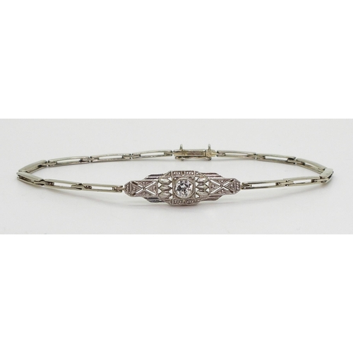 2760 - A DIAMOND ART DECO BRACELETthe white metal central pierced panel is set with a 0.20ct brilliant cut ... 