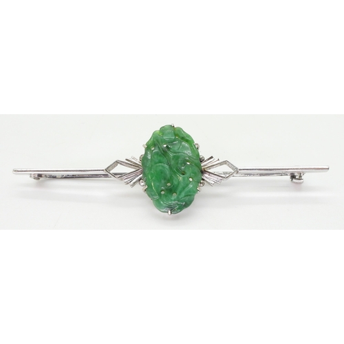 2768 - A CHINESE GREEN HARDSTONE BROOCHin a 9ct white gold Art Deco style mount, the hardstone carved with ... 