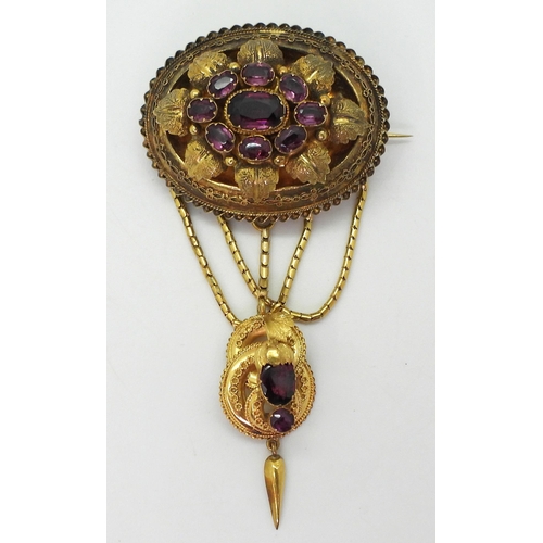 2782 - A VICTORIAN LOCKET BACK BROOCHmade in bright yellow metal, set with foiled back garnets to the centr... 