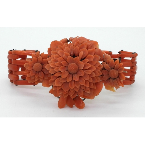 2783 - A VINTAGE CORAL BRACELETwith central flower motif, made from carved coral petals (some losses) with ... 