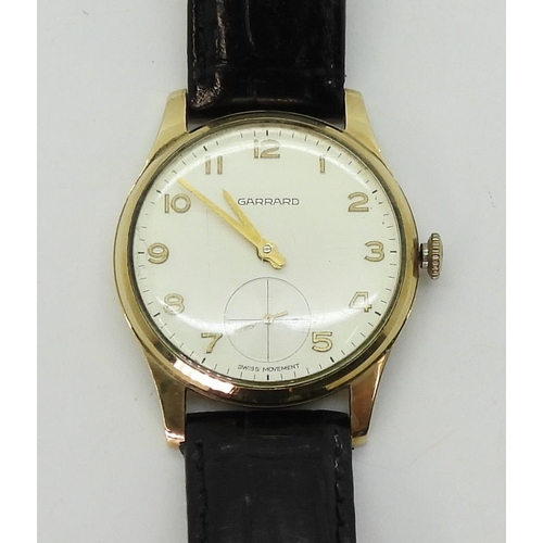 2929 - A 9CT GOLD GARRARD WATCHwith cream dial, subsidiary seconds dial, gold Arabic numerals and hands. Di... 