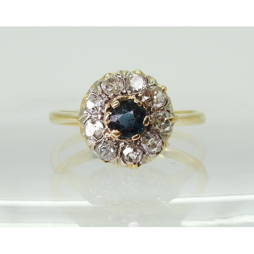 2792 - BLUE GEM & DIAMOND FLOWER RINGthe 18ct gold shank with galleried mount is set with a 4.5mm blue ... 