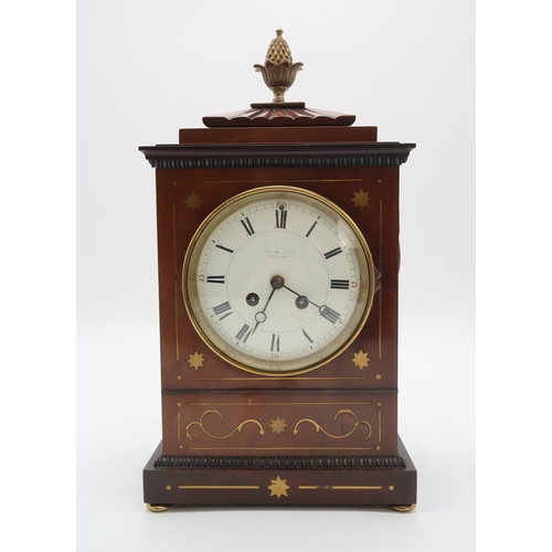 2194 - A FRENCH MAHOGANY MANTEL CLOCKthe case with inlaid brass details, and pineapple finial, the movement... 