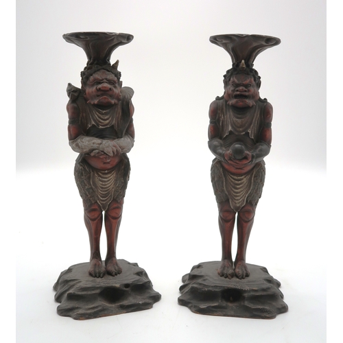 A PAIR OF CARVED WOOD,POLYCHROME AND GESSO ONI CANDLESTICKS 