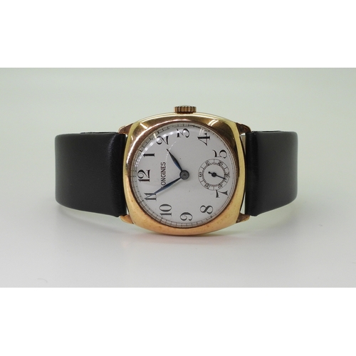 2933 - A 9CT LONGINES WATCHwith white enamel dial with  black roman numerals, subsidiary seconds dial and b... 