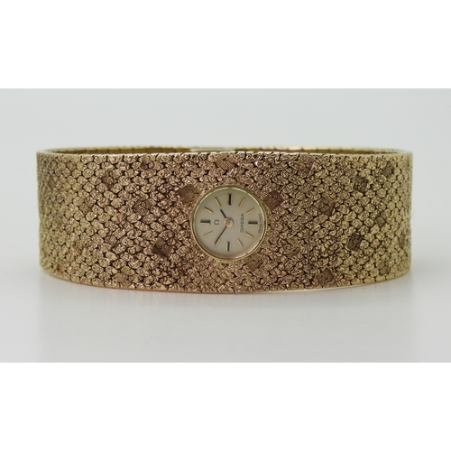 2939 - A LADIES RETRO OMEGAthe 9ct wide cuff style woven bracelet has all over texture, with a 1cm wide gol... 