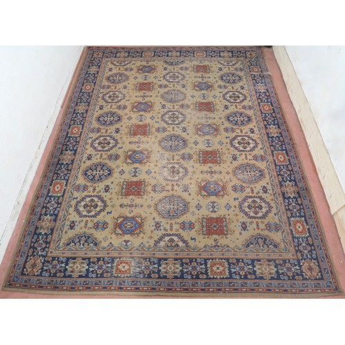 2140 - A LARGE BEIGE GROUND JAMES TEMPLETON & CO LTD STYLE RUG with all-over multicoloured lozenge desi... 