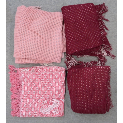 140 - A pink and blue waffle blanket, two others in burgundy and cream and a red and white throw