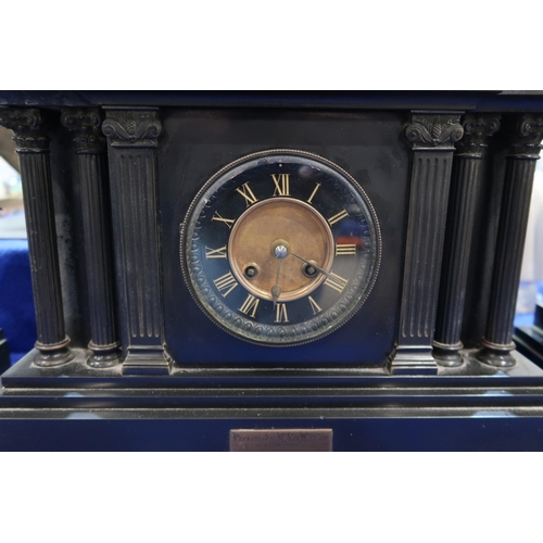 182 - A slate mantle clock with spelter Medici lion finial with a pair of urn shaped garnitures