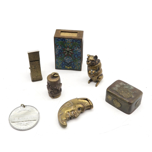 326 - A small collection of brass vesta cases, comprising pig, man-in-moon and outhouse novelty examples, ... 