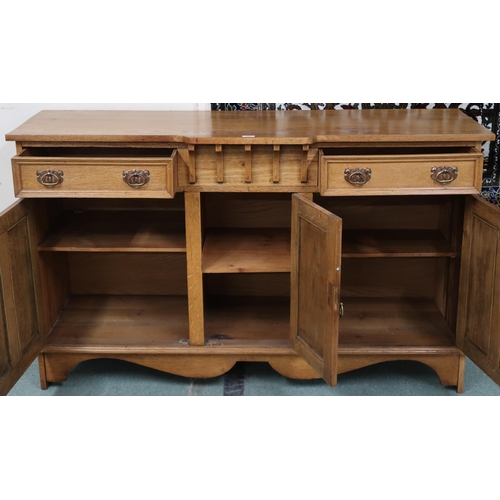 18 - A late Victorian blonde oak Arts & Crafts sideboard with shaped rectangular top over two drawers... 