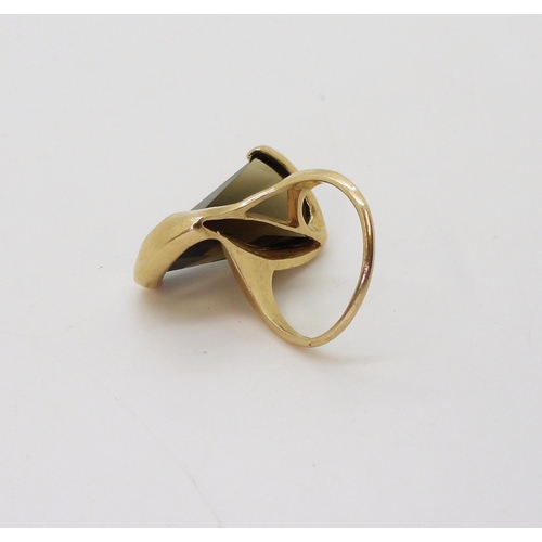 747 - A 10K gold ring set with a fantasy cut smoky quartz, London import marks for 1966, weight 8.1gms