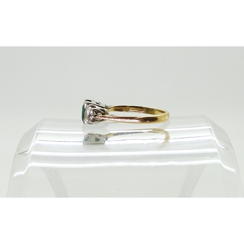 766 - An Emerald and Diamond three-stone ring, mounted in 18ct gold, set with estimated approx 0.40cts bri... 