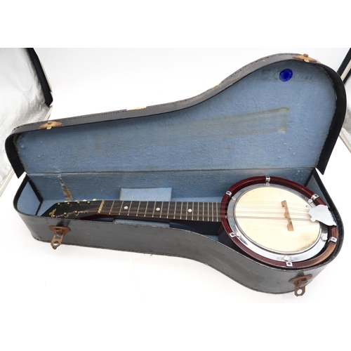 283 - A banjo mandolin 17 frets and marked British Made to the headstock with original case and a tin of p... 