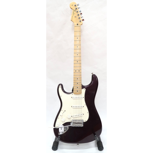 294 - FENDER STRATOCASTER a Mexican left handed electric guitar in plum with cream scratch plate. Serial n... 