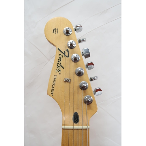 294 - FENDER STRATOCASTER a Mexican left handed electric guitar in plum with cream scratch plate. Serial n... 