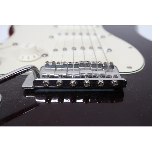 294 - FENDER STRATOCASTER a Mexican left handed electric guitar in plum with cream scratch plate. Serial n... 