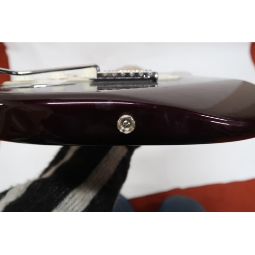 294 - FENDER STRATOCASTER a Mexican left handed electric guitar in plum with cream scratch plate. Serial n... 