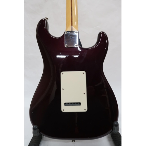 294 - FENDER STRATOCASTER a Mexican left handed electric guitar in plum with cream scratch plate. Serial n... 