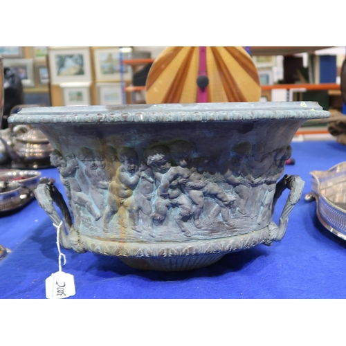 300C - A bronzed birdbath in the form of an antique urn with twin acanthus handles and figures from a bacch... 