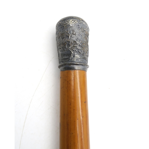 357 - A Malacca walking cane, with embossed Chinese white metal pommel, approximately 90cm in length