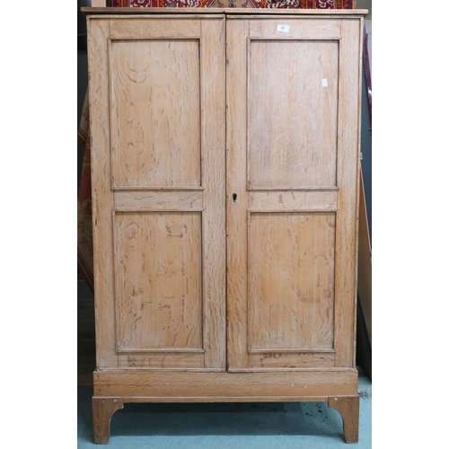 62 - An early 20th century beech two door hall robe, 146cm high x 92cm wide x 38cm deep