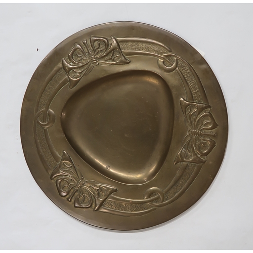 2225 - ATTRIBUTED TO MARGARET GILMOUR (1863-1942)Glasgow School, a brass charger embossed in low relief wit... 