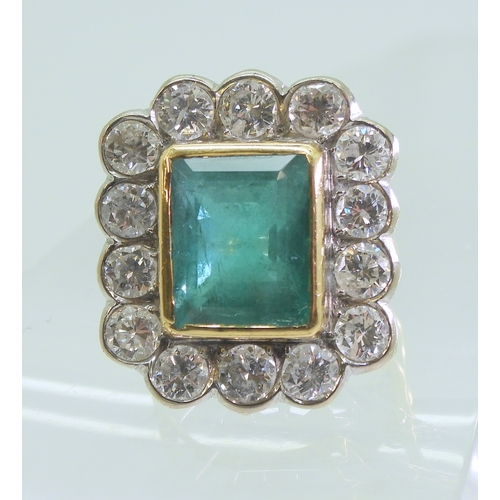 2805 - AN EMERALD & DIAMOND CLUSTER RINGthis substantial ring is set with a large step cut emerald with... 