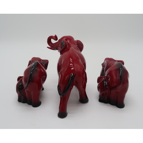 2151 - A ROYAL DOULTON FLAMBE MODEL OF AN ELEPHANT13cm high, together with two smaller groups of elephant a... 